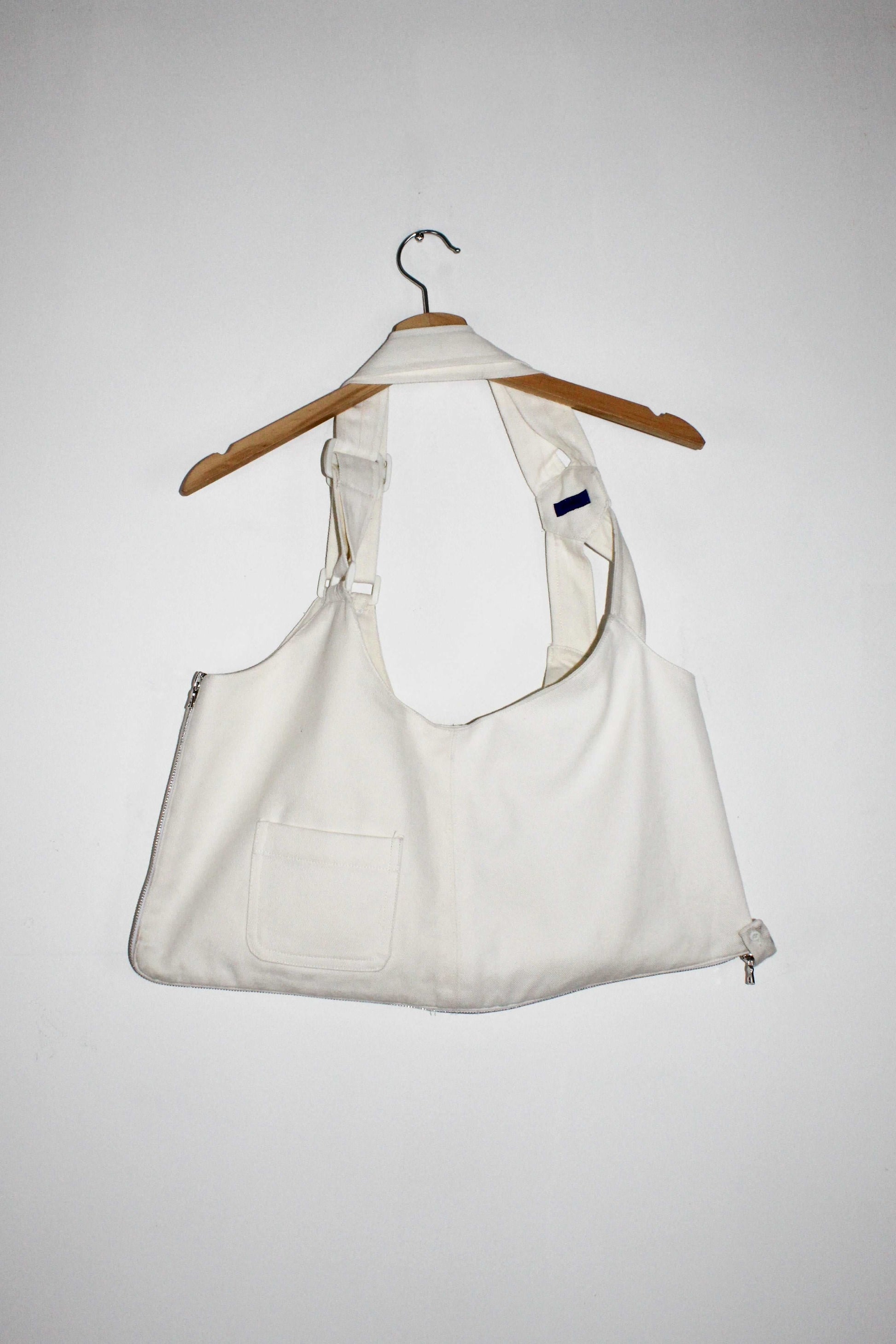 bag view White denim cropped adjustable strap convertible vest bag with cargo pockets