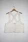 Back view White denim cropped adjustable strap convertible vest bag with cargo pockets