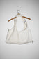bag view White denim cropped adjustable strap convertible vest bag with cargo pockets
