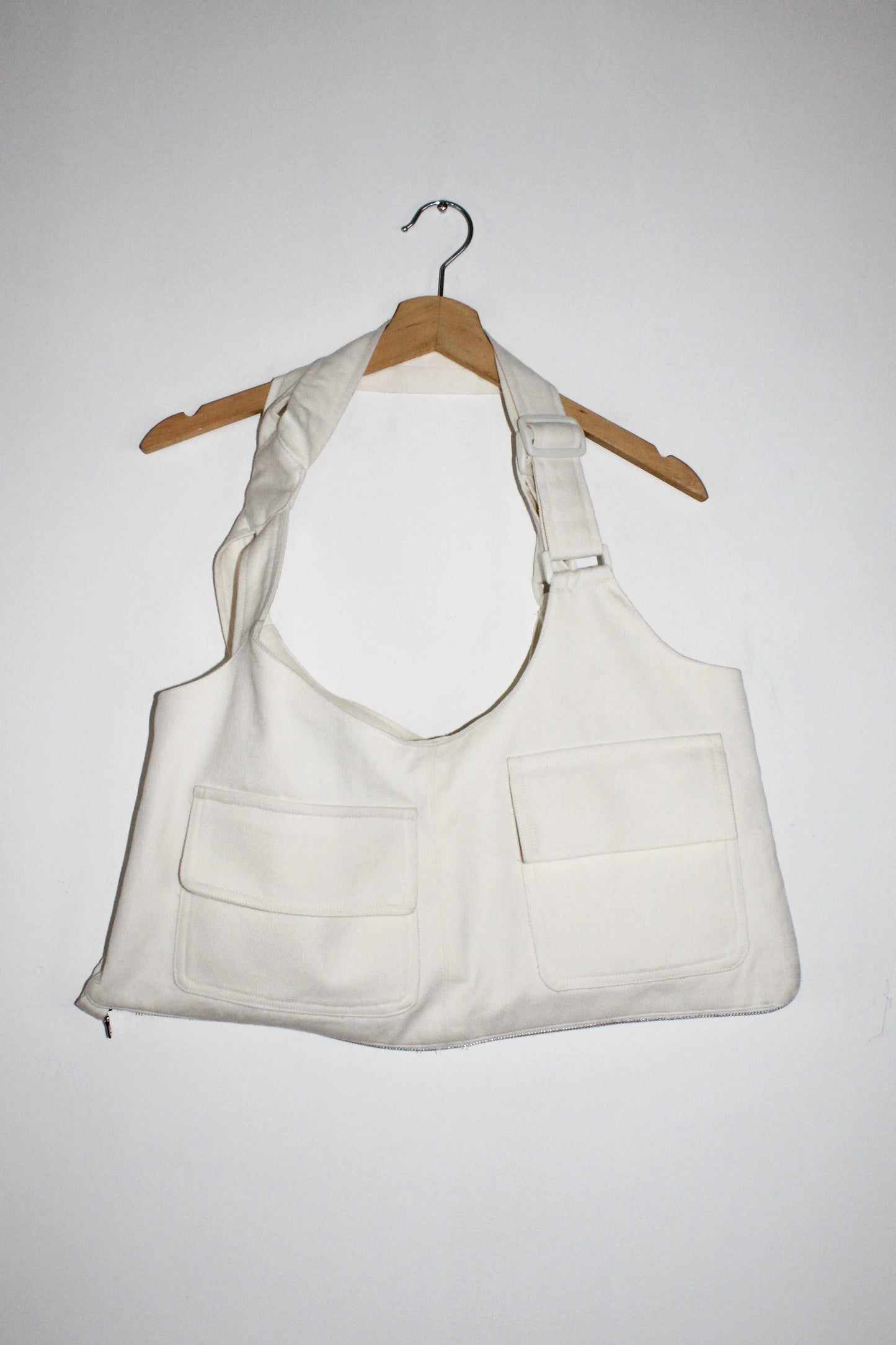 bag view White denim cropped adjustable strap convertible vest bag with cargo pockets