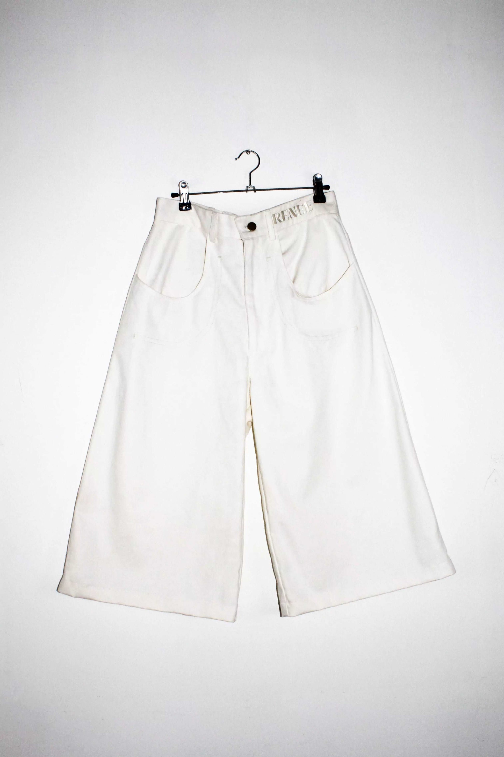 Front view lightweight long white denim shorts with removable screw buttons. Has fitted waist and 90s vintage details
