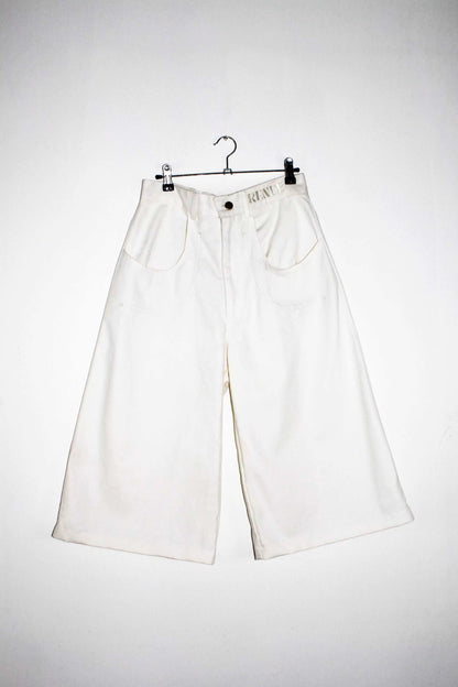 Front view lightweight long white denim shorts with removable screw buttons. Has fitted waist and 90s vintage details